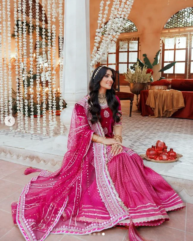 Ayeza khan sitting in a pink dress